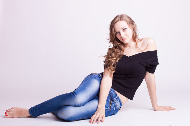A beautiful young girl in jeans, natural style - Фото, изображение
