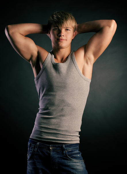 Beautiful young strong man posing on studio - Foto, Imagem