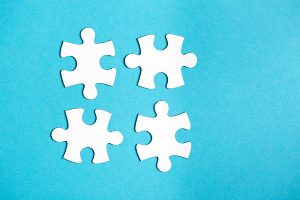 Four disconnected jigsaw puzzle pieces - Foto, afbeelding