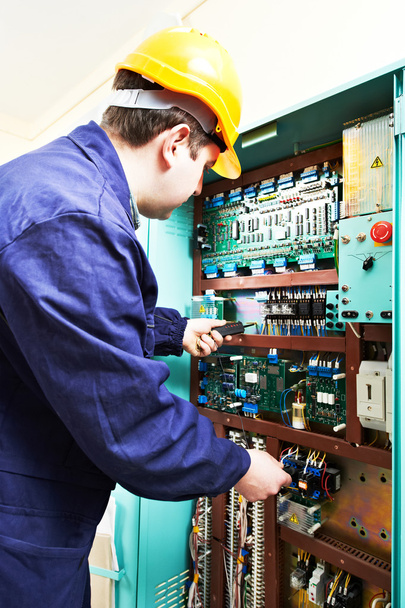 adult electrician builder engineer worker testing electronics in switch board - Photo, Image