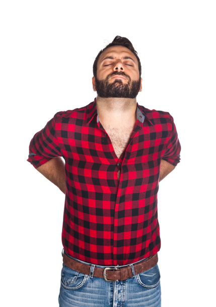 Лесоруб в клетчатой рубашке с болью в спине
 - Фото, изображение