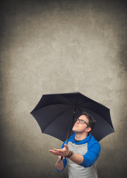 Young man with umbrella - Photo, Image