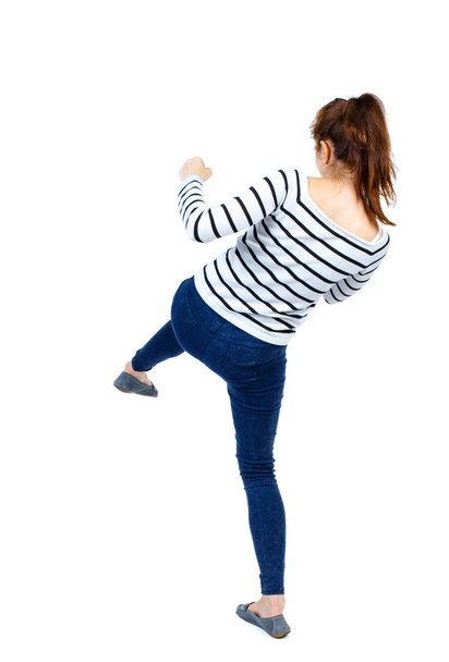 back view of woman funny fights waving his arms and legs. - 写真・画像