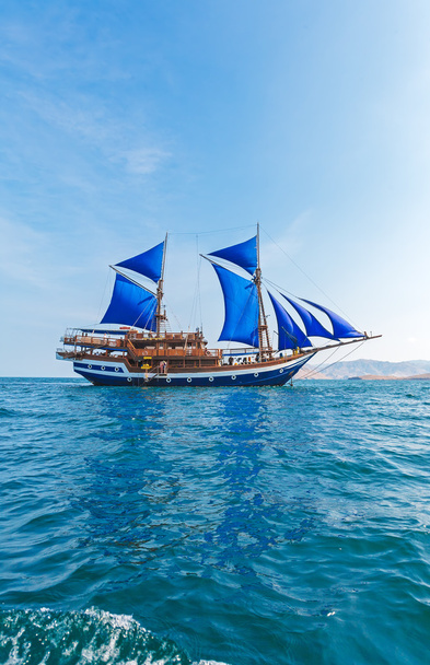 Vintage Wooden Ship with Blue Sails  - Photo, Image