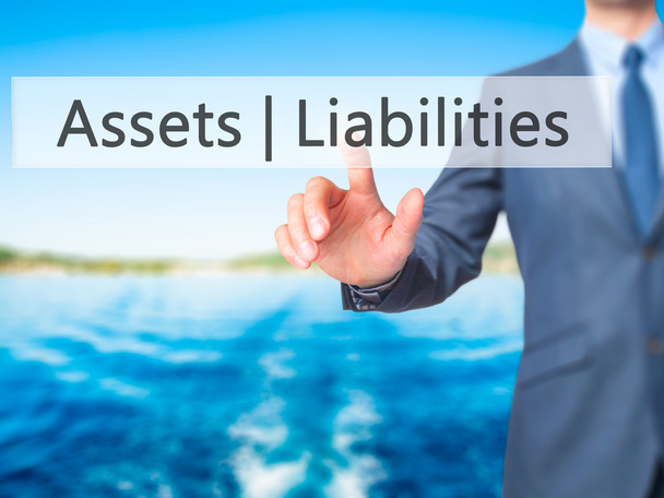 Assets Liabilities -  Businessman press on digital screen. - Photo, Image