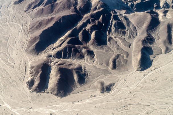 Aerial view of geoglyphs near Nazca - famous Nazca Lines, Peru. On the bottom, small Astronaut figure is present. - Фото, изображение