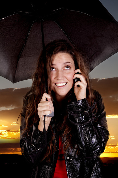 Woman on phone under umbrella - Valokuva, kuva
