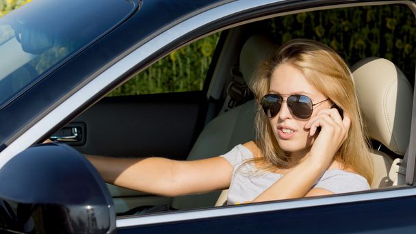 Молодая женщина водитель на мобильном
 - Фото, изображение
