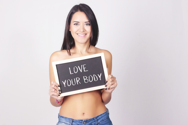 Young woman with chalkboard that says Love Your Body - Foto, Imagem