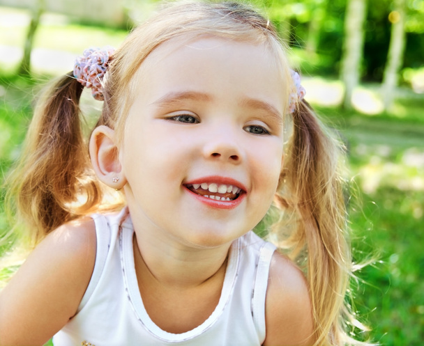 Cute little girl on the meadow - Фото, зображення