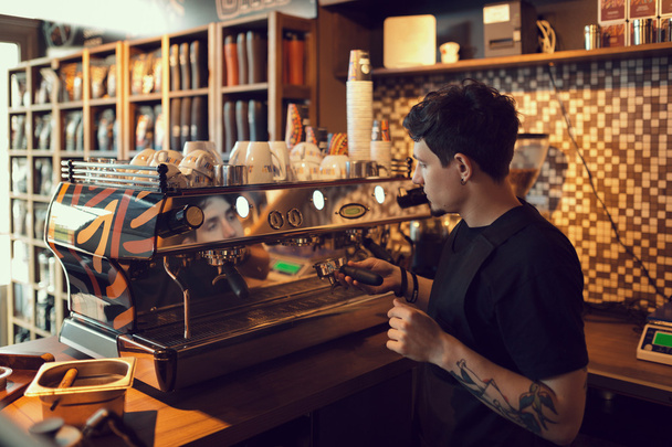 Barista at work in a coffee shop - Photo, Image