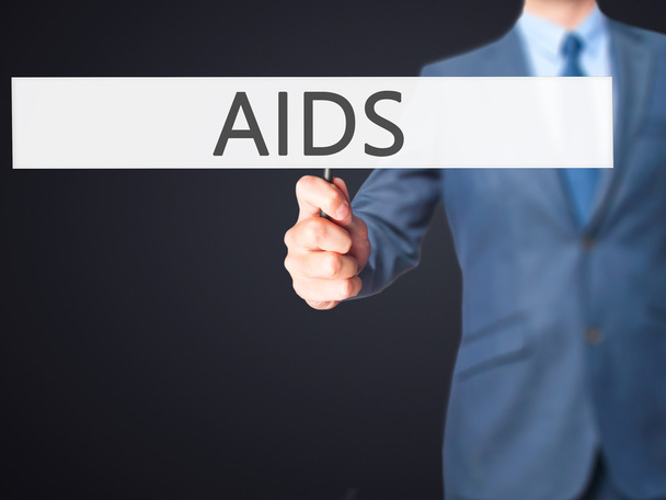 AIDS - επιχειρηματίας χέρι κρατώντας πινακίδα - Φωτογραφία, εικόνα