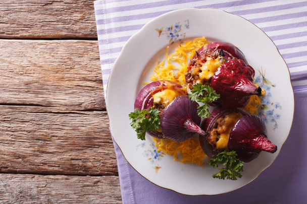 red onion stuffed with meat, vegetables and cheddar closeup. hor - Photo, Image