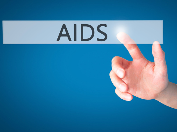 AIDS-χέρι πάτημα ενός κουμπιού σε θολή έννοια φόντο για v - Φωτογραφία, εικόνα