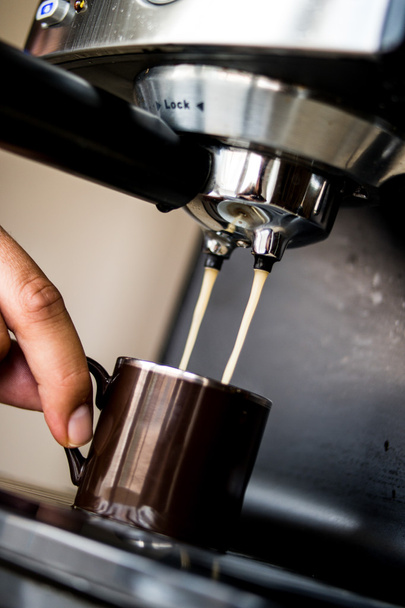 espresso machine making coffee and pouring in a brown  cup - Фото, изображение