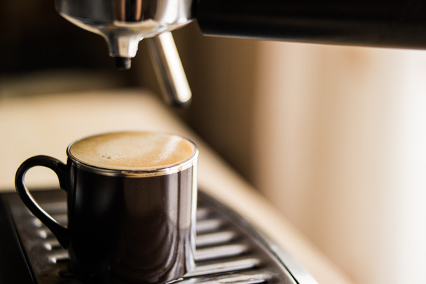 espresso machine making coffee and pouring in a brown  cup - 写真・画像