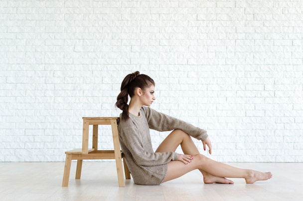 Beautiful brunette woman with wooden chair - Valokuva, kuva