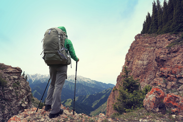 backpacker hiking on mountain peak cliff - Foto, Imagen