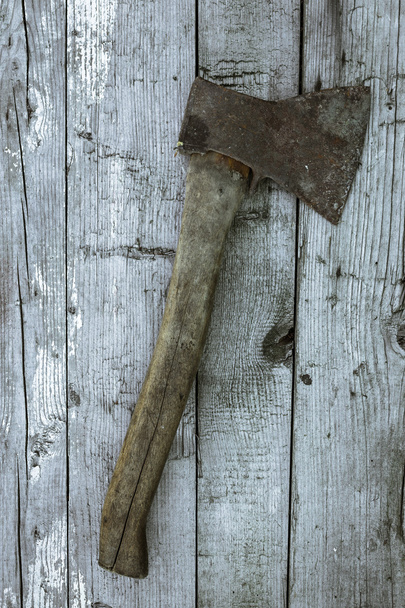 Rusty axe on wooden boards - 写真・画像