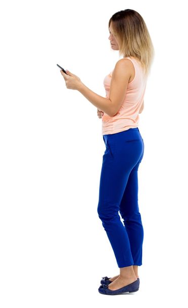 back view of standing young beautiful  girl with tablet computer - Foto, Imagen
