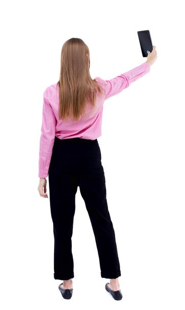 back view of standing young beautiful  girl with tablet computer - Photo, image
