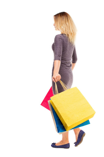 back view of going  woman  with shopping bags - Photo, image
