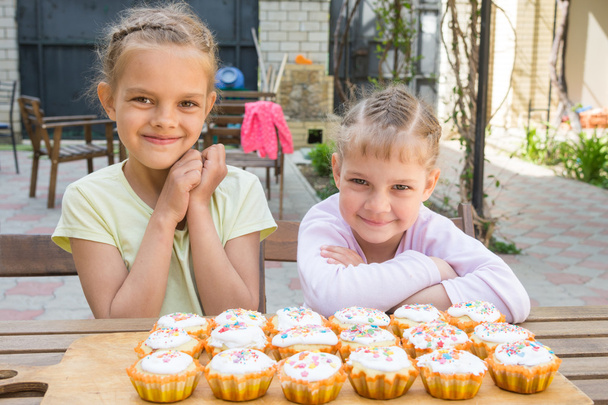 Two girls rejoice freshly baked Easter cupcakes - Photo, Image