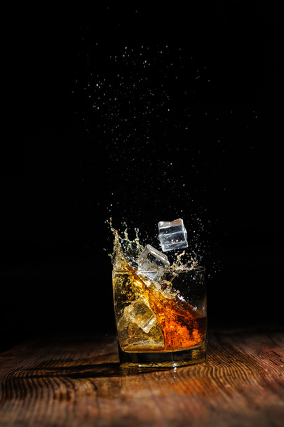 cognac on the wooden table - Фото, изображение