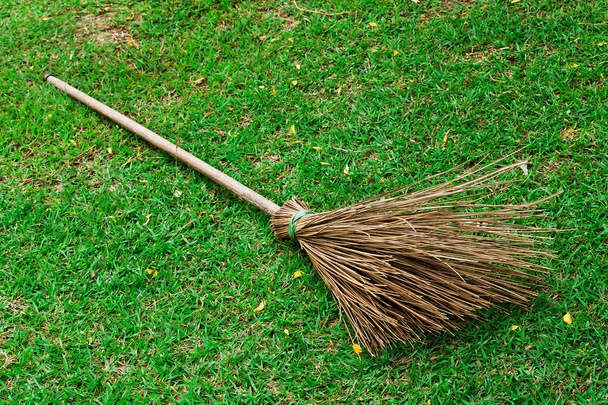 Broom on green grass in the garden - Foto, immagini