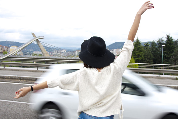 girl hitchhiking in road - Photo, Image