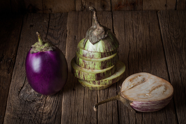 Eggplants on a rustic wooden table.  - Photo, Image