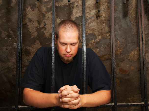 Young man behind the bars - Photo, Image