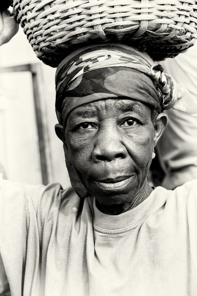 An old Ghanaian woman with a basket on her head - Photo, Image