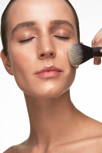 Beautiful young woman makeup closeup process - Fotografie, Obrázek