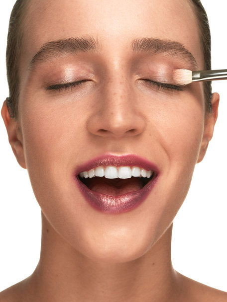 Beautiful young woman makeup closeup process - Foto, immagini