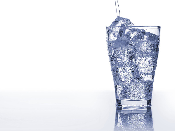 Pooring soft drink in a glass with ice - Photo, Image