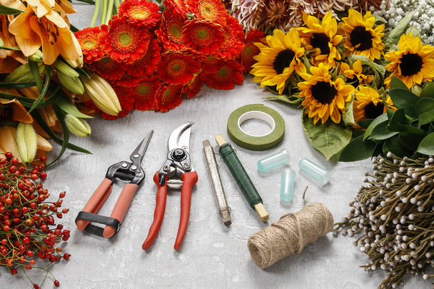 Flowers and garden tools on a gray stone background. - Foto, Imagem