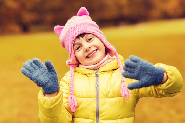 happy beautiful little girl waving hands outdoors - Foto, Bild