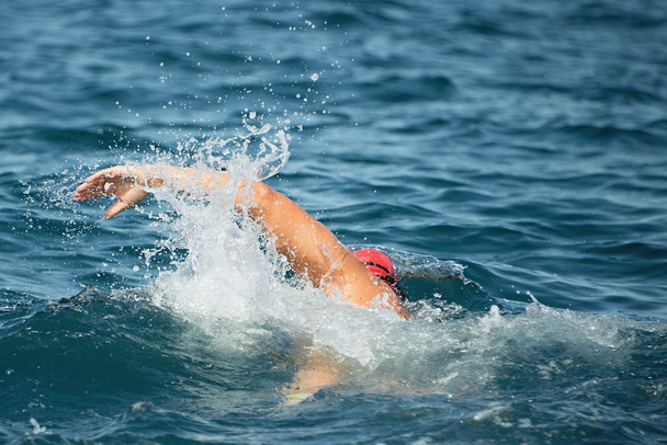 Man swimmer swimming crawl in blue sea - Photo, Image