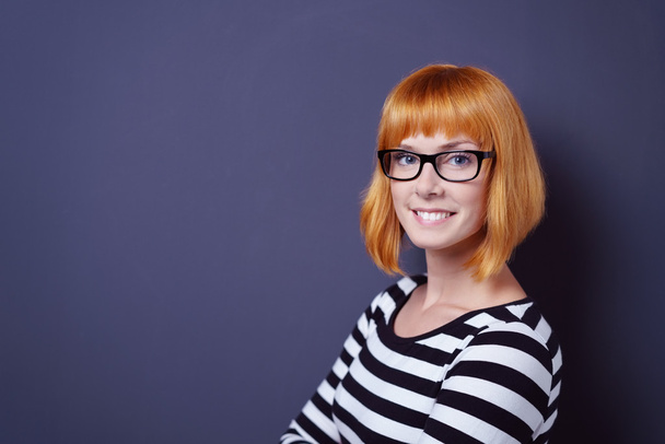 Friendly young redhead woman wearing glasses - Фото, изображение