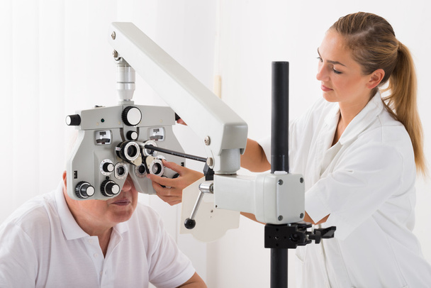 An Optometrist Doing Sight Testing For Patient - Foto, Imagen
