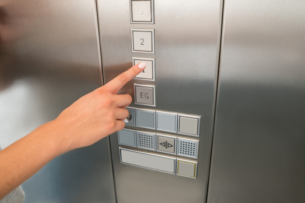 Hand Pressing First Floor Button In Elevator - Foto, afbeelding