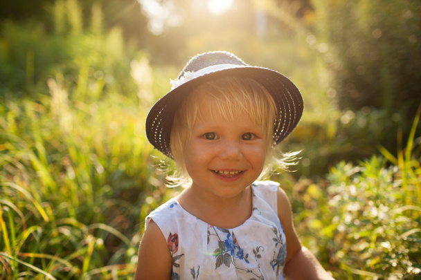 Little beautiful girl in a blue hat - Фото, изображение