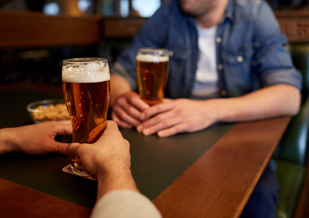 close up of men drinking beer at bar or pub - Valokuva, kuva