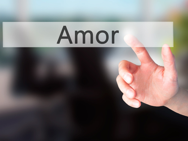 Amor - Hand pressing a button on blurred background concept on v - Photo, Image