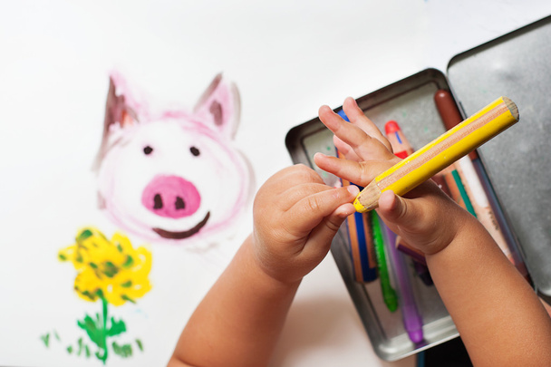 Child's hand is drawing with colorful pencils - Photo, image