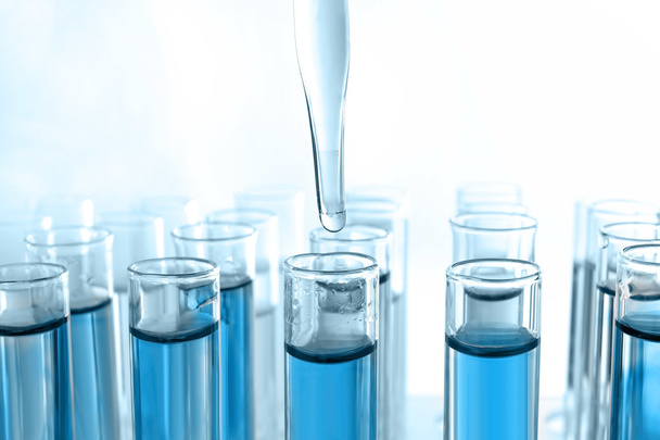 pipette dropping blue sample - Photo, image