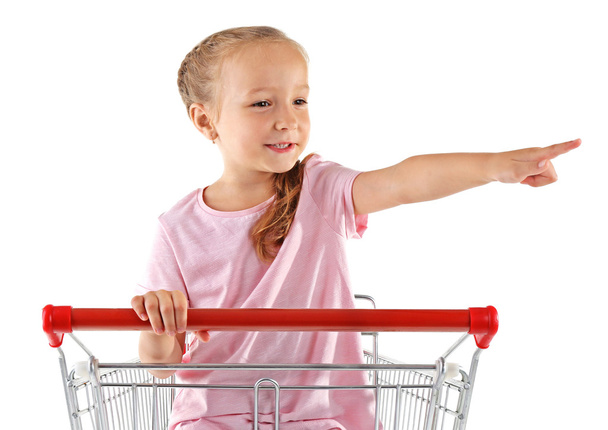 Cute girl sitting in shopping cart - Foto, afbeelding
