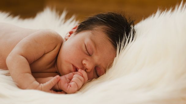 カーペットの上で眠っている新生児の肖像画 - 写真・画像