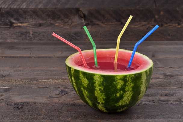 Watermelon smoothie with straws on rustic table - Fotó, kép